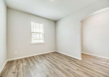 The formal dining room offers gorgeous flooring and white walls.