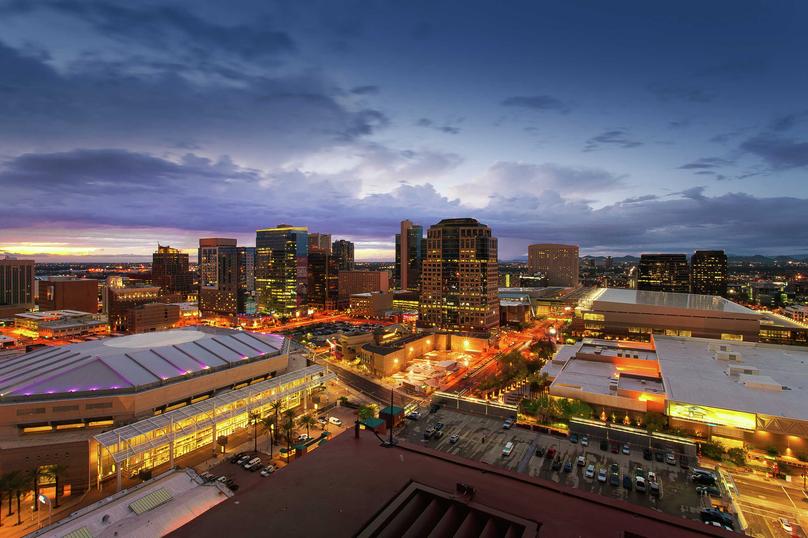 Phoenix, Arizona downtown arenas at night showing lit streets, tall office buildings, and cloudy skies