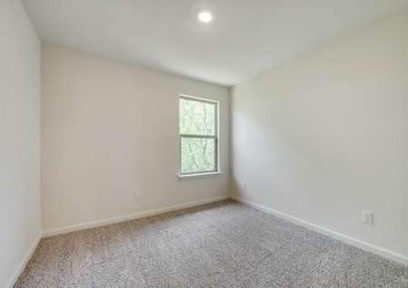 Sizable secondary bedroom with carpet and recessed lighting. 