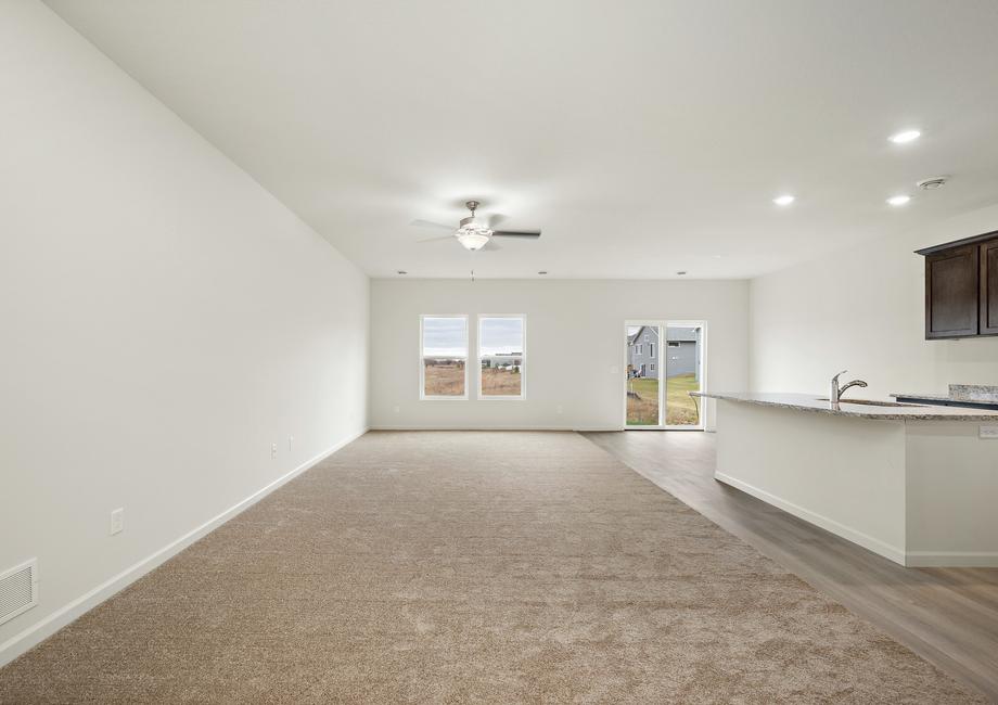 The entertainment space is spacious and includes in kitchen, dining room, and living roon