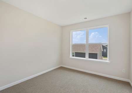 The master bedroom has brown carpet and tan walls with white trim.