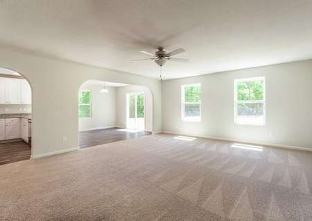 Fripp great room with dining nook, tan carpet, and windows