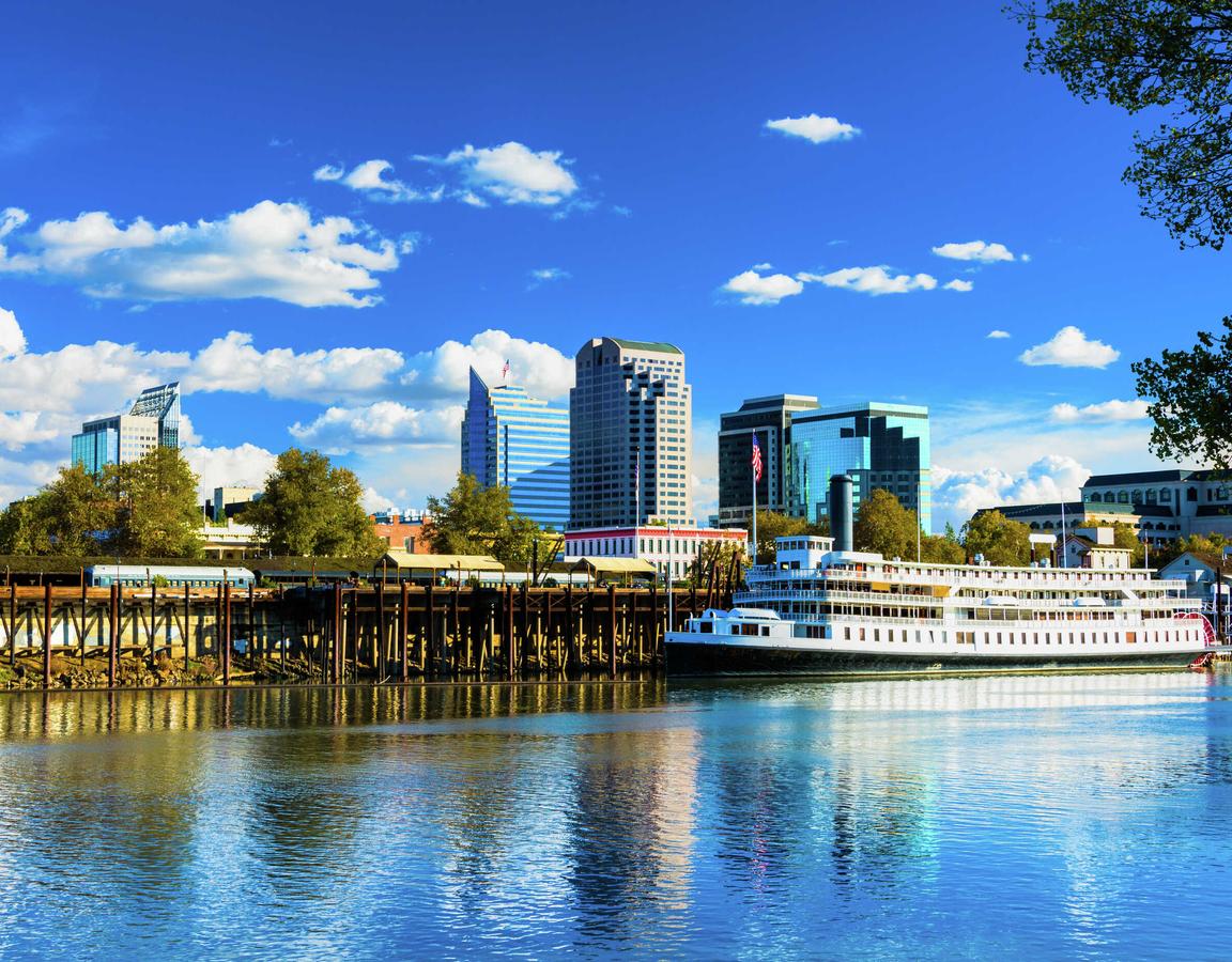 Sacramento, California Delta King riverboat on the Sacramento River showing the city