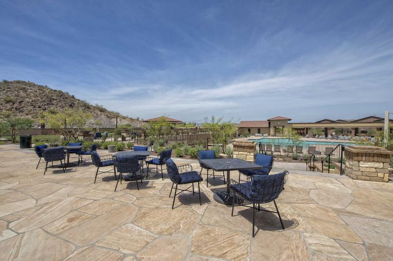 Flagstone, outdoor community area with tables and chairs close to the pool in the Estrella community