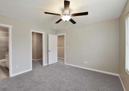Master bedroom with carpet and a ceiling fan
