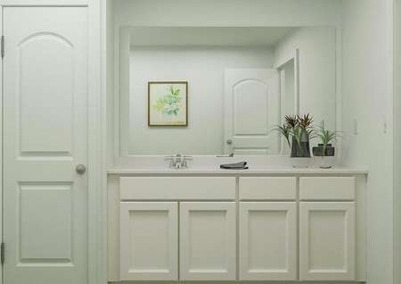 Rendering of bathroom with white
  finishes, large mirror above sink, next to linen closet.