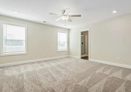 Master bedroom with carpet and a ceiling fan.