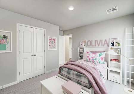 Staged child's room with pink linens.