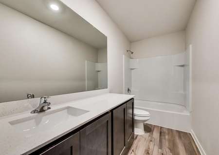 The secondary bathroom has luxury vinyl plank flooring, a shower/tub combo and great vanity.