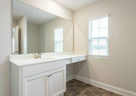Hartford master bath vanity with makeup counter, large mirror, and white finish