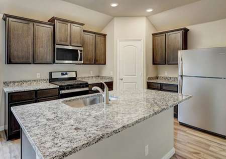 The chef-ready kitchen has stainless steel appliances and sprawling granite countertops.