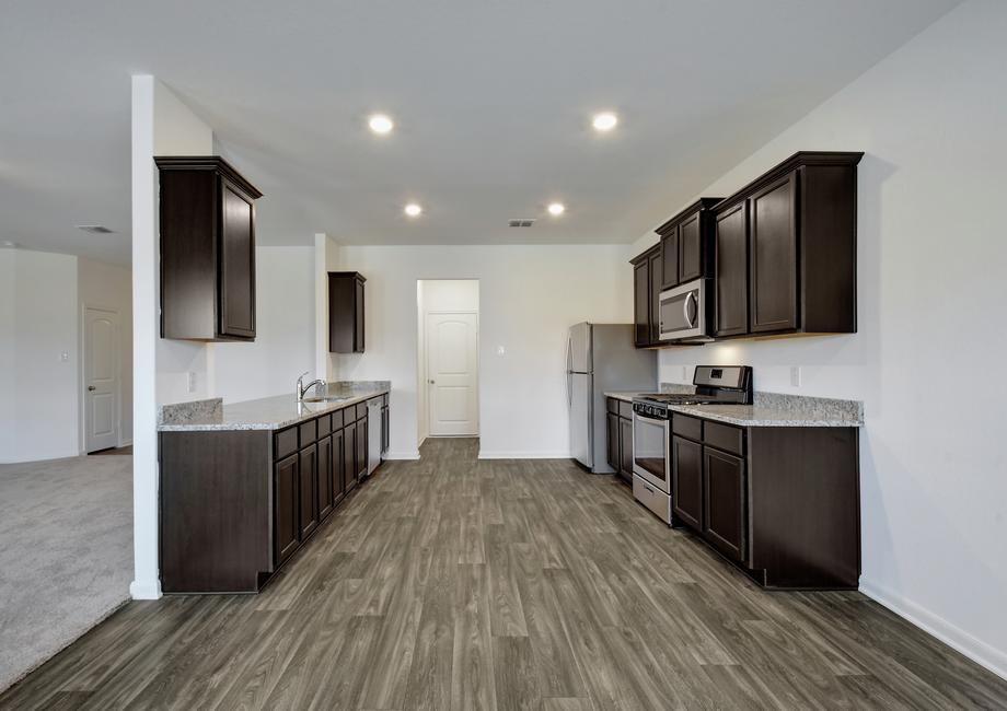 The chef-ready kitchen comes equipped with stainless appliances and granite countertops.