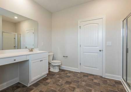 Burton master bathroom with large vanity, white appliances, and walk-in shower