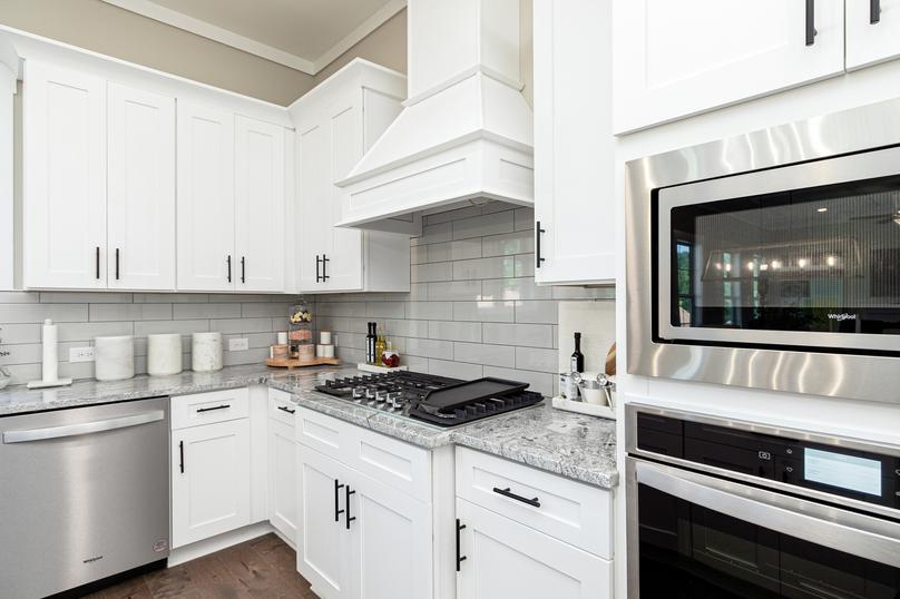 White cabinets, granite counter tops and stainless appliances.