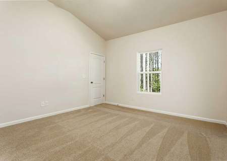 Alamance living room with vaulted ceilings, white window, and beige carpeting