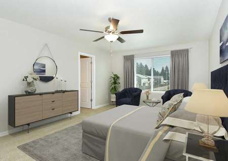 Northwest staged master bedroom with mid-century modern furnishings, carpet, ceiling fan, upstairs window view and door to bathroom.