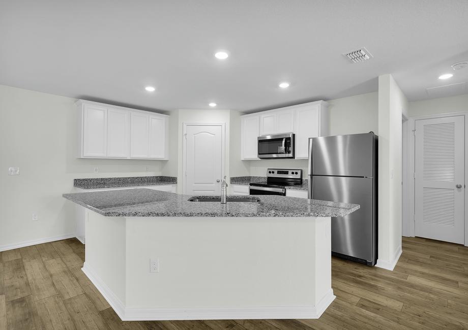 The kitchen has a large island that will be perfect for you and your family to gather around