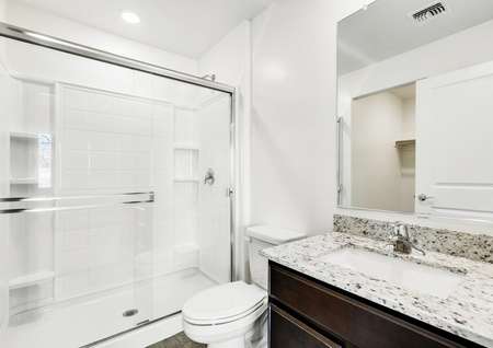 Stunning master bathroom with a walk-in shower and granite countertops.