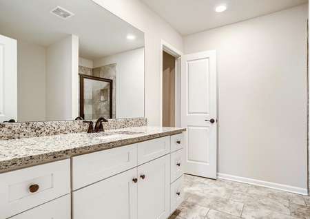 Connected to the master bedroom is the private master bath with a garden tub and walk-in shower.