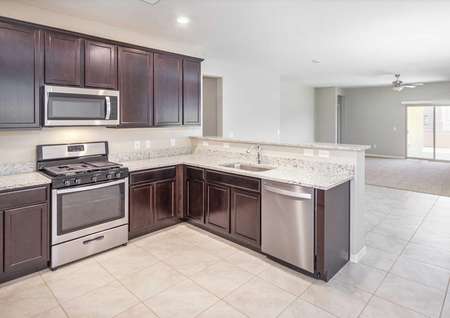 Prescott kitchen with stainless steel appliances, granite countertops, and espresso cabinets.