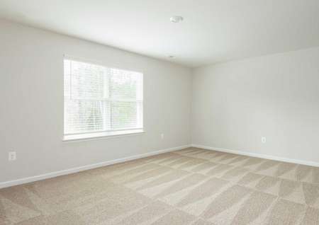The Mid Atlantic Waverly showing a spacious carpeted master bedroom with a large window.