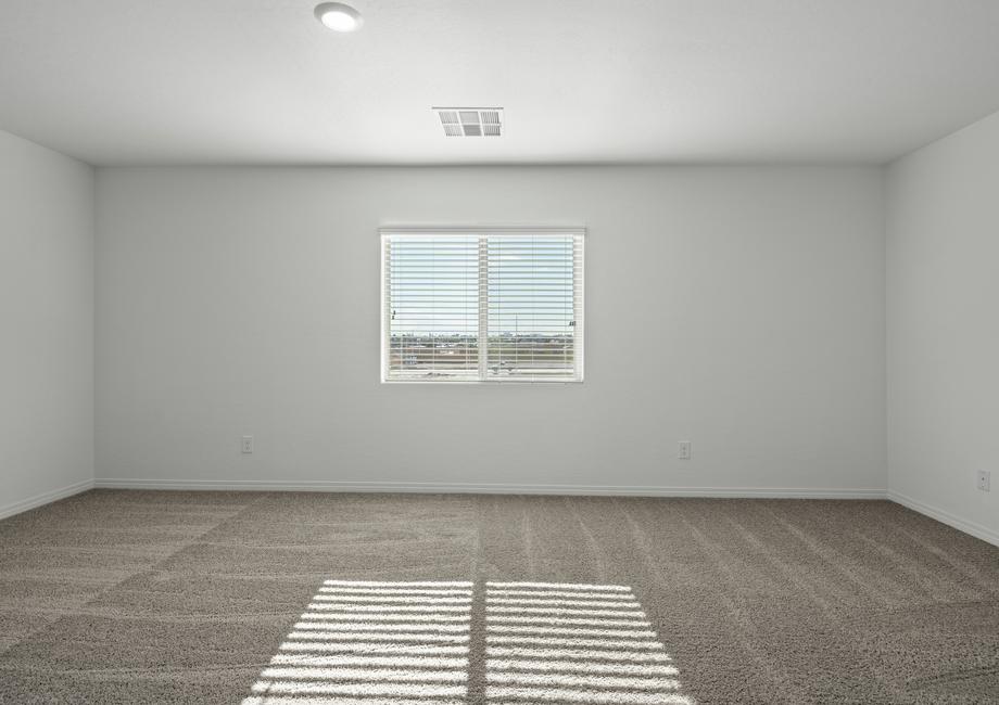The master bedroom with a large window and carpet