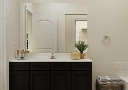 Rendering of the master bath in the Maple focused on the vanity with brown cabinetry.