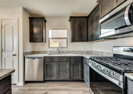 The kitchen features stainless steel appliances with a gas stove.