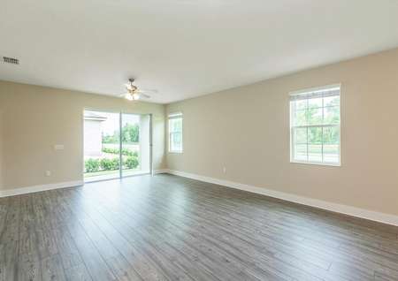 Spacious family room with plenty of natural light entering through the sliding doors and windows.
