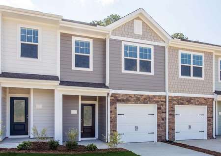 The Bradford A elevation with an attached garage and stone accent detailing.