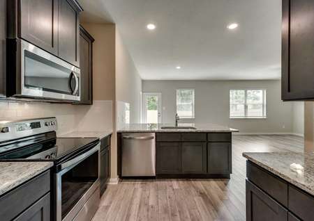 St. Clair kitchen with hardwood floors, granite countertops, and modern stainless steel appliances