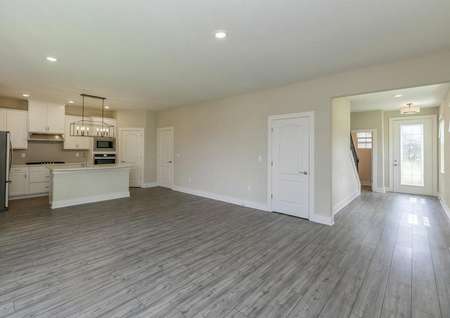 Open-concept layout showcasing a family room, chef-ready kitchen and the home's beautiful entrance.