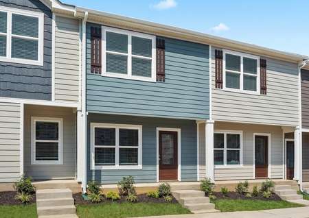 Beautiful townhome with blue siding and a three-quarter lite front door.