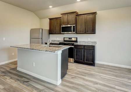 The chef-ready kitchen has brown cabinetry, light granite and light flooring.