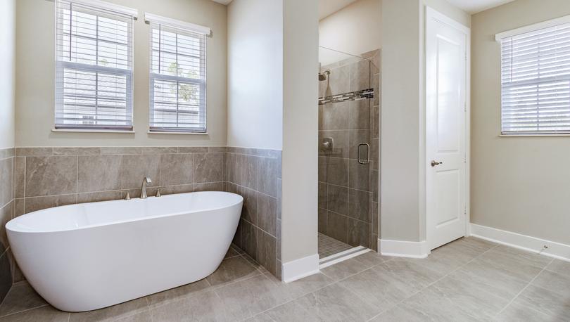 Master bathroom with tile floors, a walk-in shower and a standalone tub.