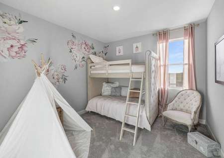 Mead kid's bedroom with bunk beds, white Victorian chair, and flower wall decals