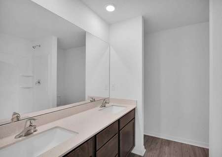 The spacious master bathroom featuring double sinks.