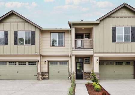A beautiful two-story townhome with siding and a balcony