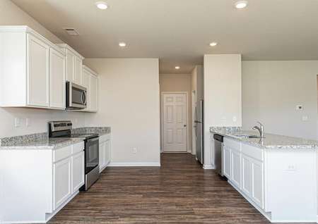 The kitchen has plenty of storage in its beautiful white cabinets