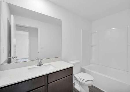 A secondary bathroom centrally located in the home. 
