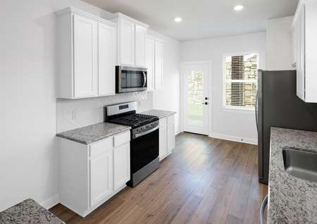 Kitchen with white cabinets and stainless appliances