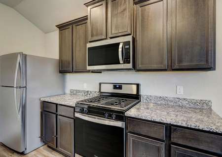 This kitchen comes with a full suite of stainless steel appliances and granite countertops.