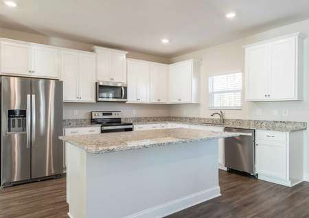 Chef-ready kitchen with large island and stainless steel appliances.