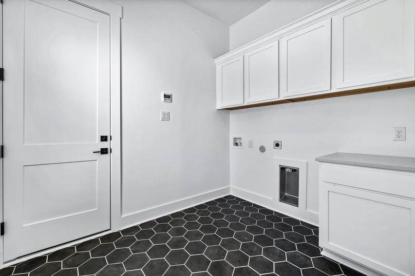 The mud room offers additional storage space and the perfect setup for laundry.