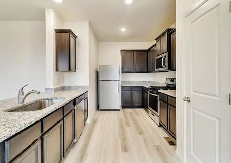 Incredible kitchen with granite countertops, stainless appliances, and wood-style flooring. 