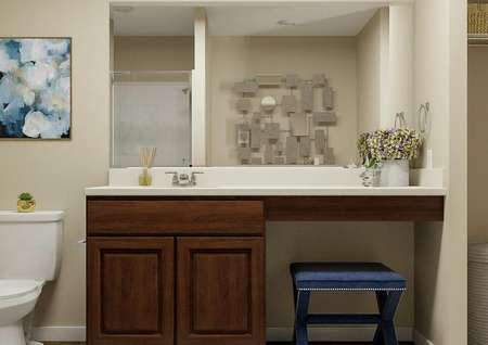 Rendering of the
  spacious master bath with brown cabinet vanity flanked by a white toilet and
  linen closet.