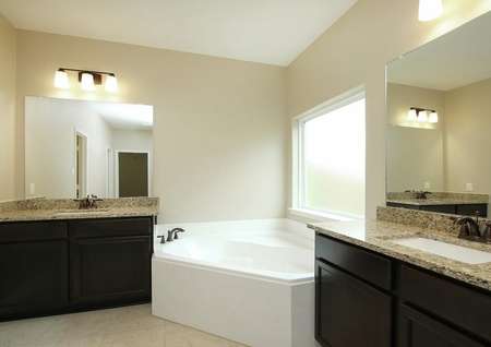 Master bathroom with two sink and a soaking tub
