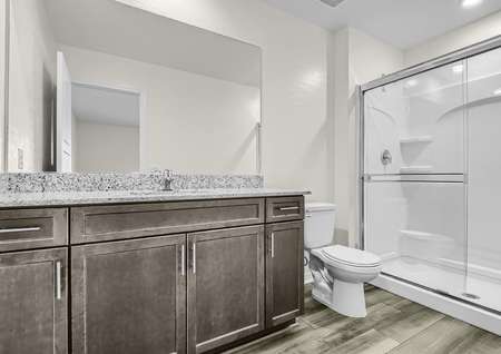 A full bathroom with great vanity space and a sizable shower. 