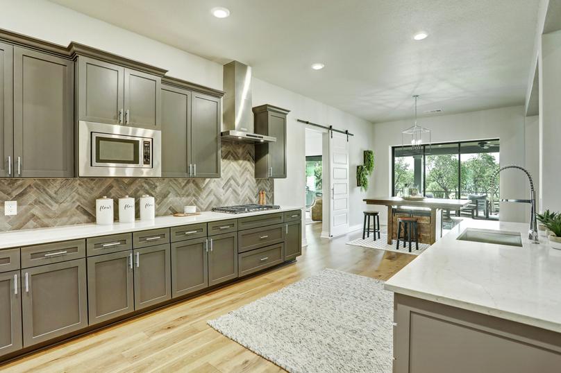 The kitchen comes with stunning wood cabinetry and quartz countertops.