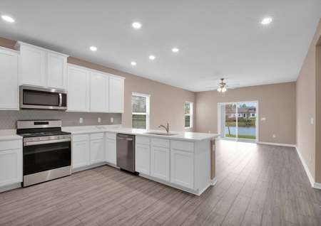 An open-concept floor plan allows for the kitchen to overlook the home's entertainment space. 